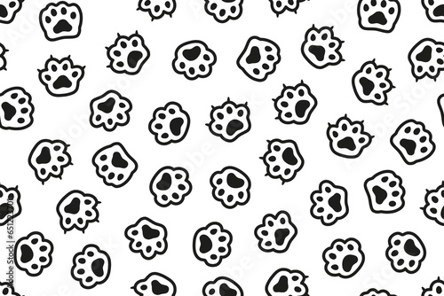 Black and white seamless pattern with cat footprints.  Silhouette cat paw doodle seamless pattern. 