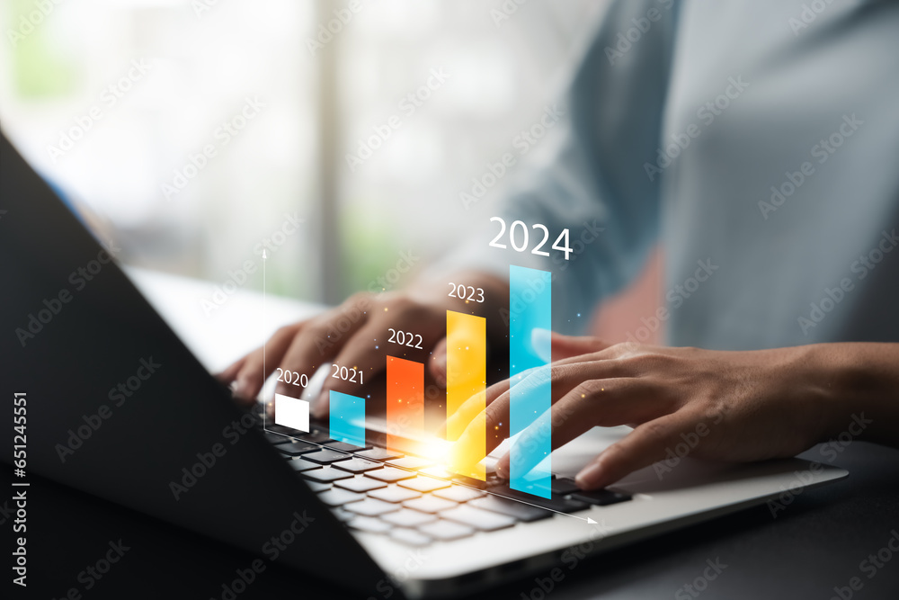 Businesswoman analyzes profitability of working companies with digital augmented reality graphics, positive indicators in 2024, businessman calculates financial data for long-term investments. - obrazy, fototapety, plakaty 