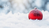 Macro shot of red Christmas ornament on snow backdrop. Isolated with copy space for text