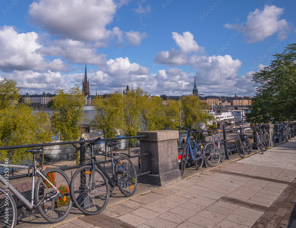 Slope with bicycles at the pier Södermälarstrand, cumulus clouds, a sunny autumn day in Stockholm