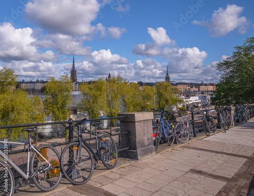 Slope with bicycles at the pier Södermälarstrand, cumulus clouds, a sunny autumn day in Stockholm © Hans Baath