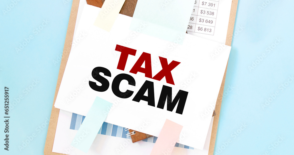 Paper plate with text take TAX SCAM. Diagram, notepad and blue ...