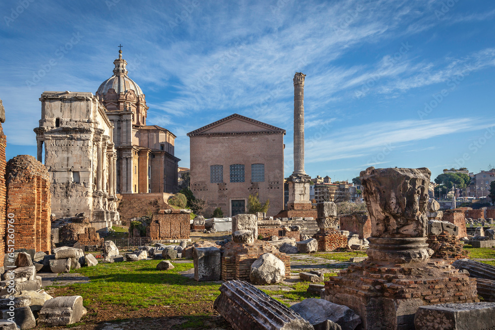 Roman ruins with Curia, Rostra and Triumphal Arch of Septimius Severus on the Roman Forum in Rome, Italy