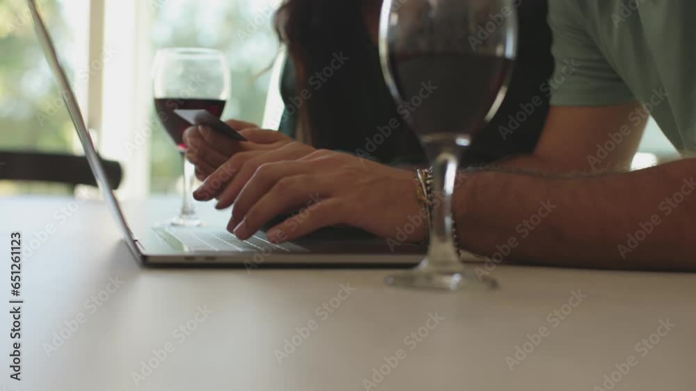 male hands typing on laptop - couple at home buying on line male hands typing on laptop - couple at home buying on line