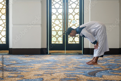 Muslim men praying in Ruku posture