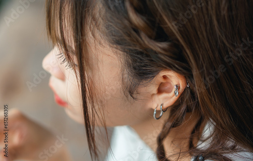 close-up of ear asian woman with earring fashion concept