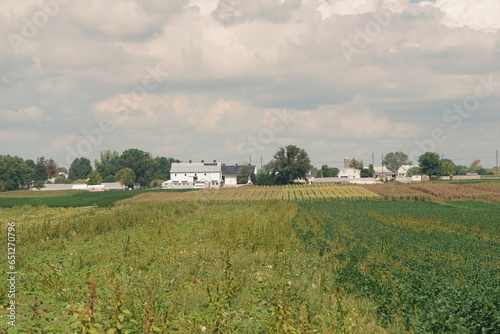 Farmscape of White Buidling, Fields, Trees, and Sky in Summer, Lancaster, Pennsylvania photo