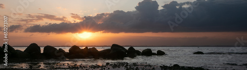 Panoramic view to scenic seascape with dramatic sky at sunset.
