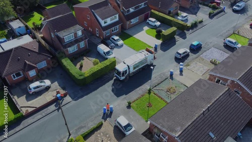 Drone. Waste collection truck in urban street collecting trash. Filmed. Yorkshire.UK.  photo