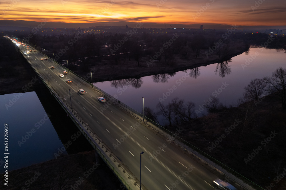 Nowa Huta Bridge (Most Nowohucki) in Krakow, Czyżyny, sunset in the city, late-night traffic, drone shot, aerial photography, aerial city view, Vistula river - obrazy, fototapety, plakaty 