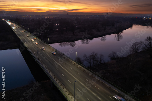 Nowa Huta Bridge (Most Nowohucki) in Krakow, Czyżyny, sunset in the city, late-night traffic, drone shot, aerial photography, aerial city view, Vistula river