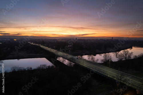 Nowa Huta Bridge (Most Nowohucki) in Krakow, Czyżyny, sunset in the city, late-night traffic, drone shot, aerial photography, aerial city view, Vistula river