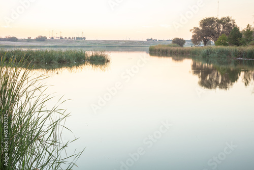 Landscape photo at Dunbar Historical Lake Lubbock Texas of sunrise over water photo