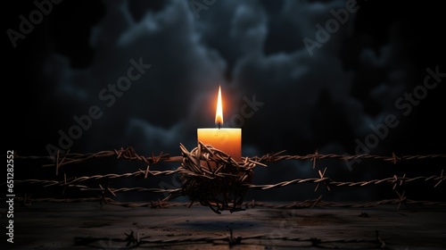 International Holocaust Remembrance: A solemn composition featuring the David star, barbed wire, and a burning candle on a dark background.