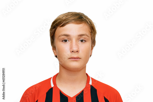 Close up portrait of young 12 - 13 years old teenager boy wearing football soccer uniform photo