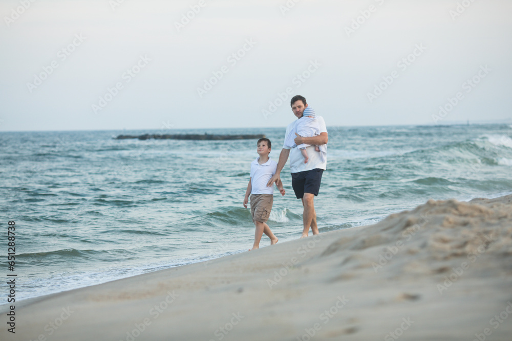 Father and child playing on tropical beach at sunset. Family summer vacation at sea resort. Dad playing with kids on sunny evening at ocean shore. Travel with children. Parent love Father and child playing on tropical beach at sunset. Family summer vacation at sea resort. Dad playing with kids on sunny evening at ocean shore. Travel with children. Parent love