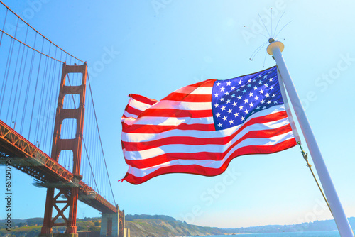The US flag flown from cruise ship underneath there Golden Gate Bridge in San Francisco, CA