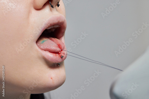 tongue splitting. cutting the tongue, one type of modification of the human body. surgery concept.