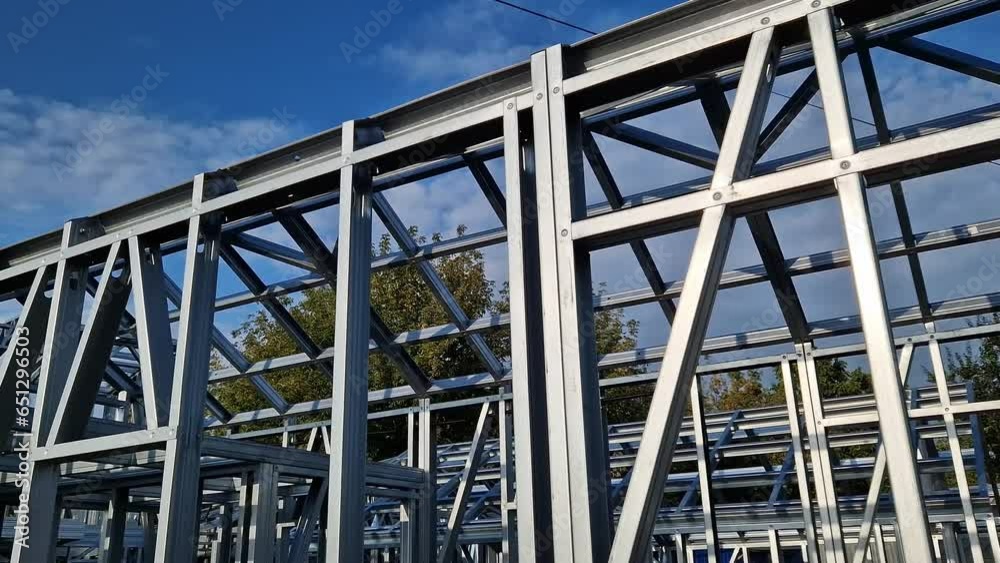 Lightweight steel thin-walled structures. Frames for warehouses, garages or houses. Structure of a steel frame for construction against the sky