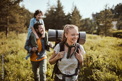 Photography Happy young Caucasian family hiking through the forest in the mountains