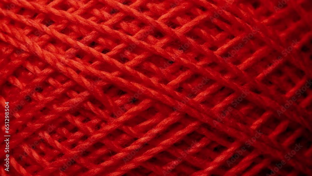 Texture of threads in a spool of pink color.