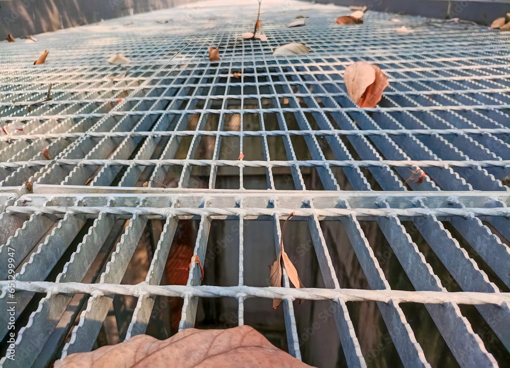 Installation of hotdip galvanized steel grilles on basement vents to