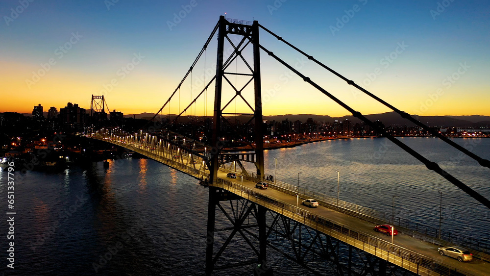 Obraz premium Sunset at Florianopolis Bridge. Santa Catarina Brazil. Sunset at cityscape of downtown Florianopolis state of Santa Catarina Brazil. Tropical island. International travel destinations.