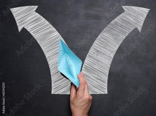 Canvas Print Hand holding a blue paper boat, concept of finding solutions, choosing direction