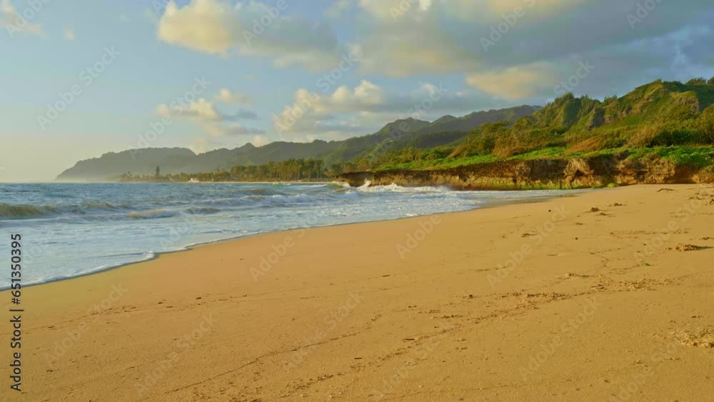 Sandy beach during golden hour with waves crashing in the distance. Peaceful and calm. Sandy beach during golden hour with waves crashing in the distance. Peaceful and calm.
