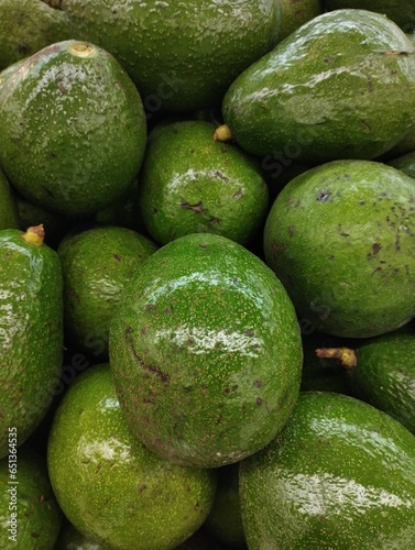 Close-up photo of a pile of avocados (Persea americana) in a supermarket, this fruit contains vitamins and minerals which are good for our heart.