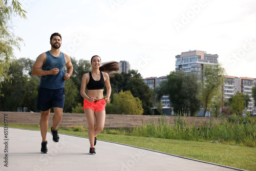 Fototapeta Naklejka Na Ścianę i Meble -  Healthy lifestyle. Happy couple running outdoors, space for text