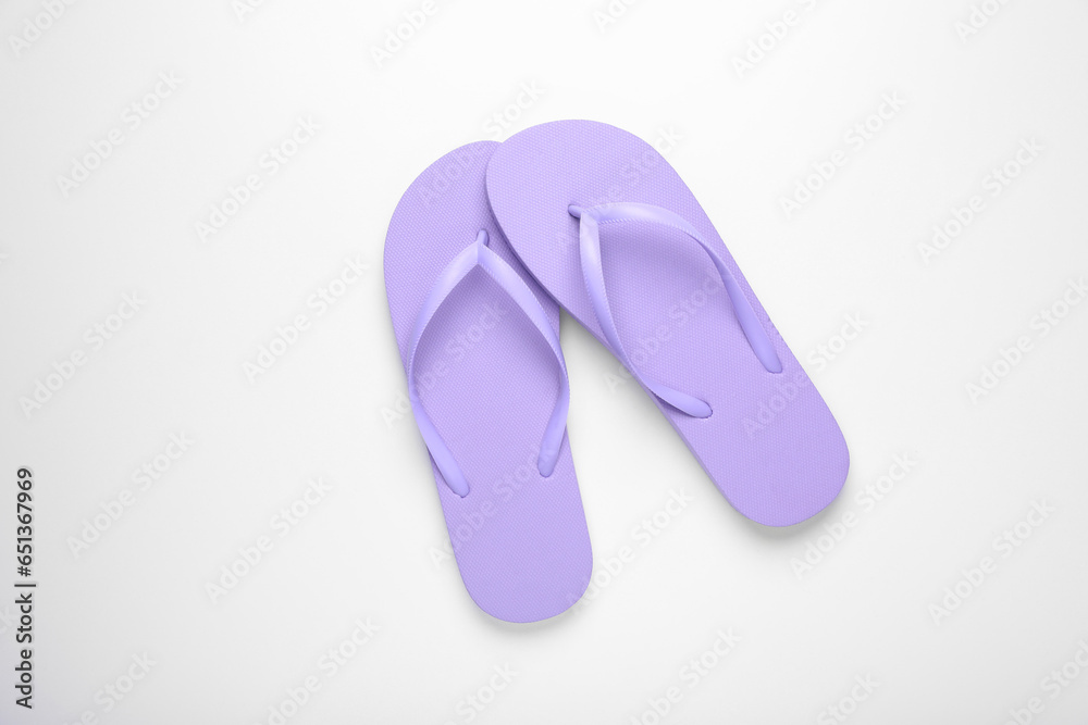 Stylish violet flip flops on white background, top view Stylish violet flip flops on white background, top view