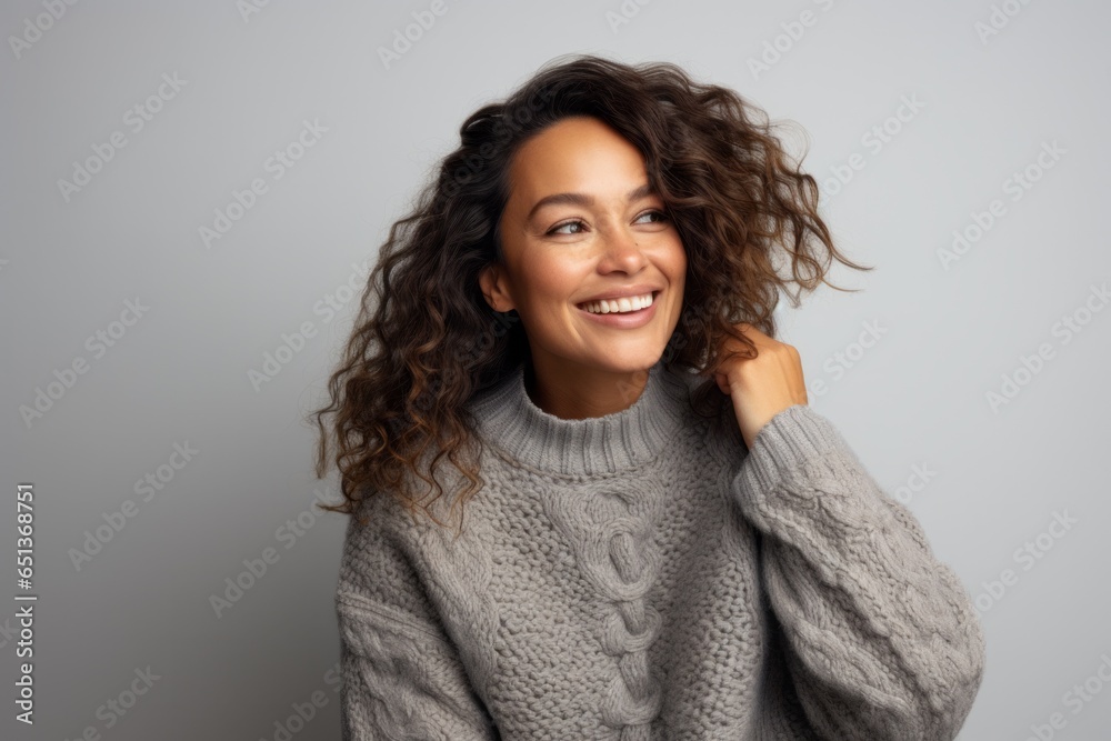 Lifestyle portrait photography of a Peruvian woman in her 30s wearing a cozy sweater against a white background Lifestyle portrait photography of a Peruvian woman in her 30s wearing a cozy sweater against a white background