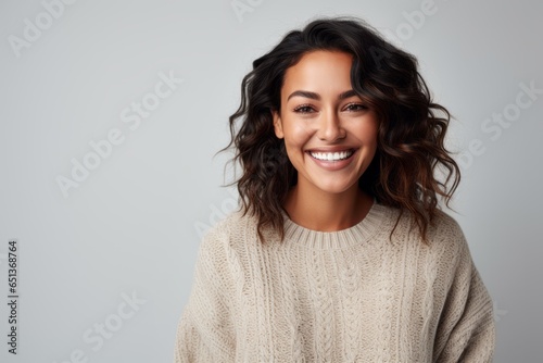 Medium shot portrait photography of a happy Peruvian woman in her 30s wearing a cozy sweater against a white background