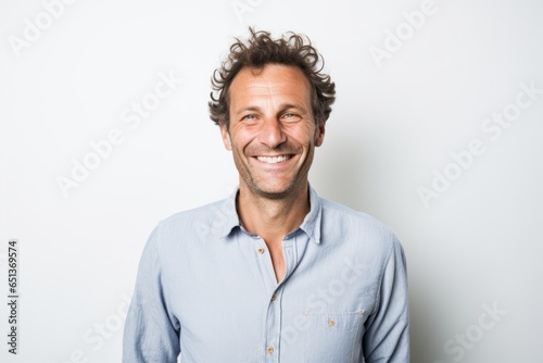 Lifestyle portrait photography of a happy French man in his 40s against a white background