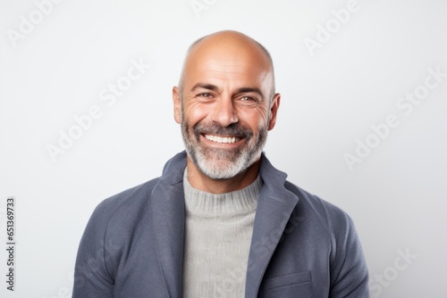 Lifestyle portrait photography of a happy Italian man in his 40s against a white background photo