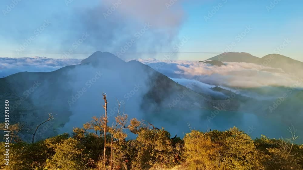 Aerial view of Kawah Ijen volcano with turquoise sulfur water lake at sunrise.Amazing nature landscape view at East Java, Indonesia. Natural landscape background Aerial view of Kawah Ijen volcano with turquoise sulfur water lake at sunrise.Amazing nature landscape view at East Java, Indonesia. Natural landscape background
