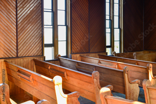 Carta da parati Interior of a vintage church with wooden pews or benches of red wood