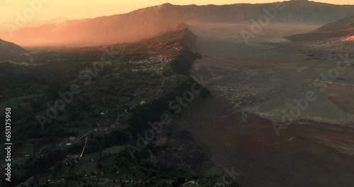 Aerial view 4k by drone of beautiful view village in the sunrise morning, near Mount Bromo. Located in Bromo, Tengger, Semeru National Park, East Java, Indonesia. Aerial view bromo volcano concept. photo