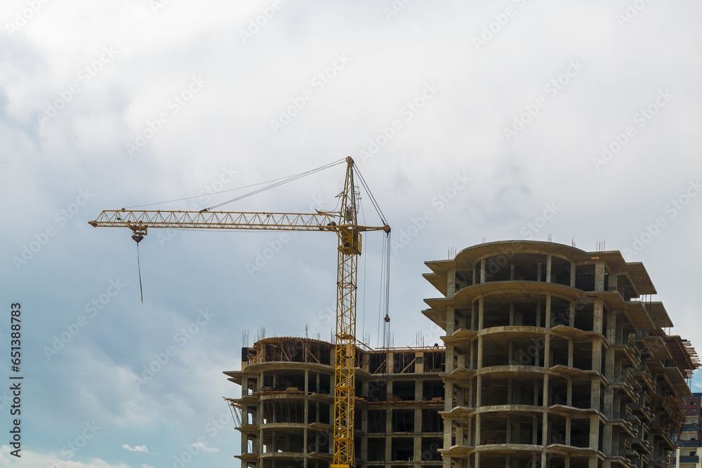Construction of a multi-storey residential building in a new area with a crane. Construction of a multi-storey residential building in a new area with a crane.