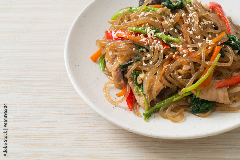japchae or stir-fried Korean vermicelli noodles with vegetables and pork topped with white sesame japchae or stir-fried Korean vermicelli noodles with vegetables and pork topped with white sesame