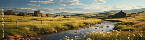 In an ultrawide panorama a picturesque stone house by a meandering dirt road with a gentle stream  surrounded by expansive green fields and rolling hills under a sunny sky  bordered by eclectic fences