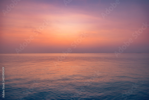 Beautiful closeup sea water surface. Sunset sunrise light orange gold blue colors calm soft waves relaxing horizon. Dream fantasy majestic seascape sky. Tranquil peaceful nature pattern, Mediterranean