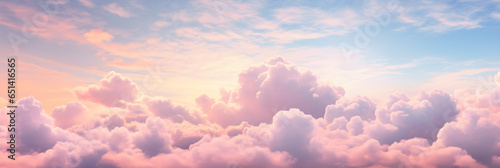 Beautiful background image of a romantic blue sky with soft fluffy pink clouds. Panoramic natural view of a dreamy sky © sam