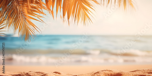 Beautiful background for summer vacation and travel. Golden sand of tropical beach, blurry palm leaves and sea on sunny day © sam