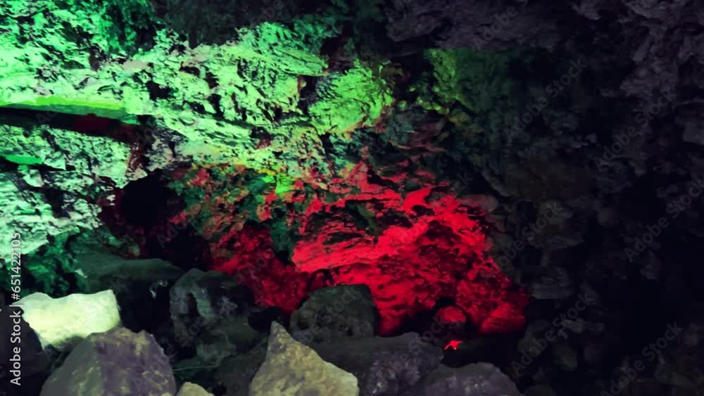 Excursion to the dark ice cave in winter. Underground large stone cave ...