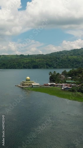 Aerial view of Linuk Mosque and Lake Lanao in Lanao del Sur. Blue sky and clouds. Mindanao, Philippines. Vertical view. photo