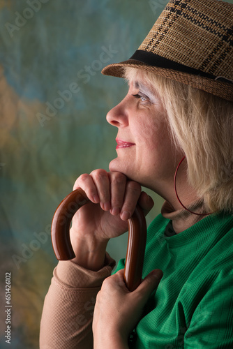 Model in a hat and jacket. Emotional look. Artistic background.