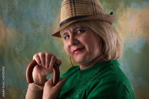 Model in a hat and jacket. Emotional look. Artistic background.