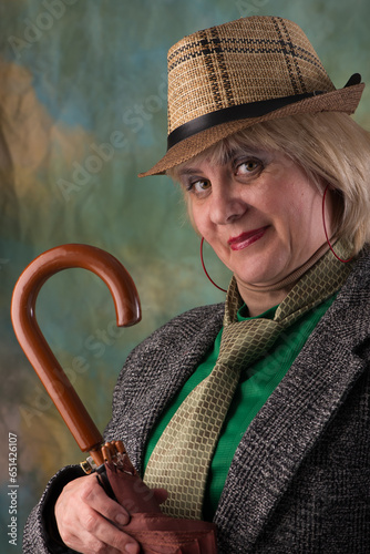 Model in a hat and jacket. Emotional look. Artistic background.